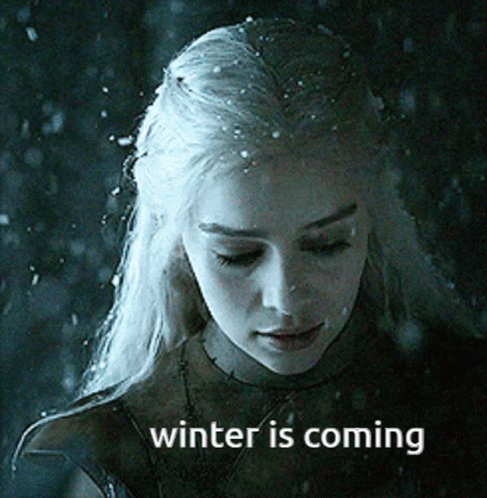 A Woman With Snow On Her Hair And The Words Winter Is Coming On The Bottom GIF