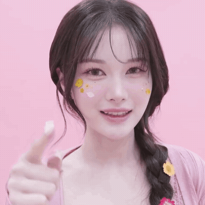 A Woman With Stickers On Her Face Is Pointing Her Finger GIF