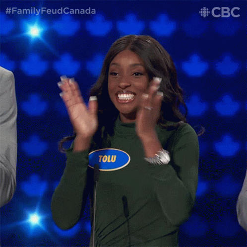 A Woman With The Name Tolu On Her Shirt Is Clapping GIF