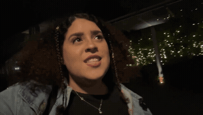 A Woman With The Word Demure On Her Face GIF