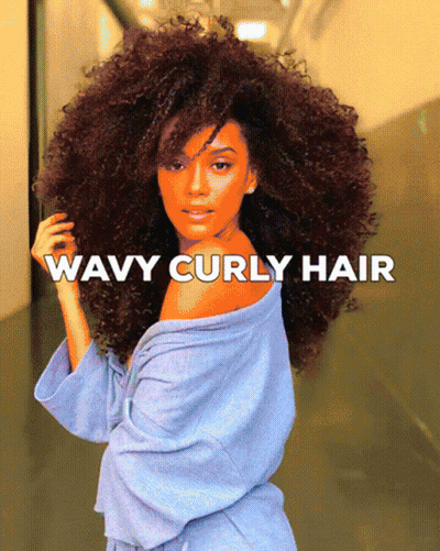 A Woman With Wavy Curly Hair In A Blue Robe GIF