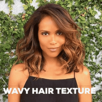 A Woman With Wavy Hair Is Wearing A Black Tank Top And Standing In Front Of A Wall . GIF