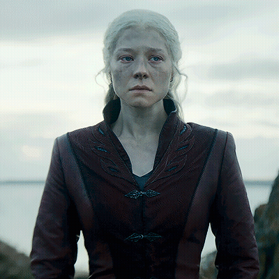 A Woman With White Hair Is Wearing A Burgundy Leather Jacket GIF