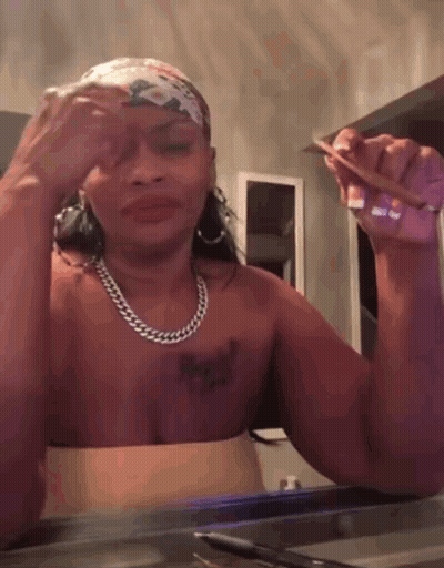 A Woman Without A Shirt Is Holding A Piece Of Paper In Her Hand GIF