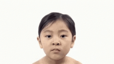 A Woman Without A Shirt Is Looking At The Camera With A Serious Look On Her Face . GIF