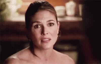 A Woman Without A Shirt Is Making A Funny Face . GIF