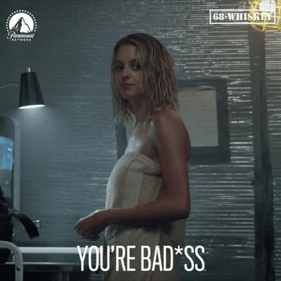 A Woman Wrapped In A Towel With The Words You 'Re Bad Ss Below Her GIF