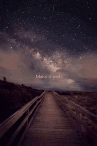 A Wooden Bridge With The Words Make A Wish Written In The Sky GIF