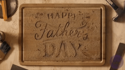 A Wooden Cutting Board With The Words Happy Father 'S Day Carved Into It GIF