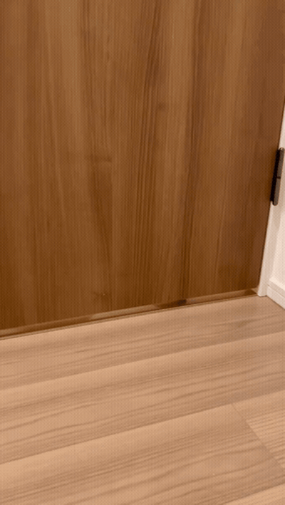 A Wooden Door With A Metal Door Stop On The Floor Underneath It GIF