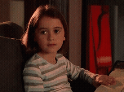 A Wooden Door With A Stained Glass Window Is Open To A Patio . GIF