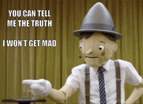 A Wooden Puppet With A Hat And Suspenders Is Pointing At Someone GIF