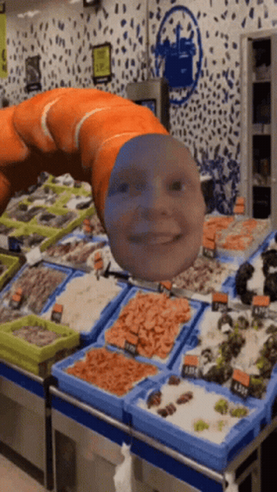 A Worm With A Face On It Is In A Seafood Market GIF