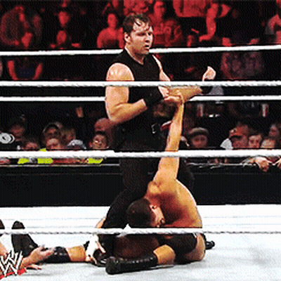 A Wrestler In A Black Tank Top Is Wrestling Another Wrestler GIF