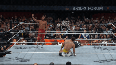 A Wrestler In A Ring With A Sign That Says " Aew " On It GIF