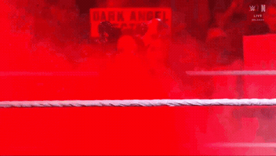 A Wrestler In A Ring With A Sign That Says Dark Angel On It GIF