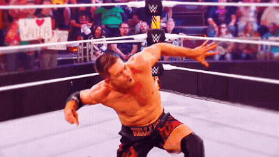 A Wrestler In A Ring With A Sign That Says I Love You GIF