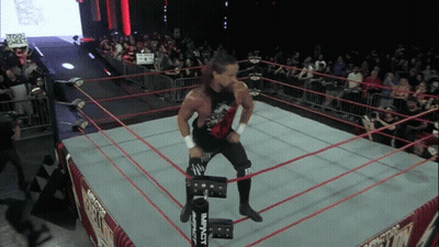 A Wrestler In A Ring With A Sign That Says Too Sweet On It GIF