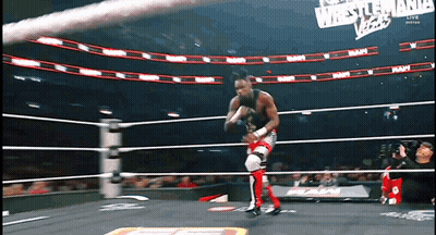 A Wrestler In A Ring With A Sign That Says Wrestlemania Vegas GIF