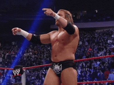 A Wrestler In A Wrestling Ring With The Letter W On The Side Of His Belt GIF