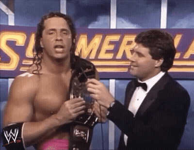 A Wrestler Is Being Interviewed By A Man In A Tuxedo In Front Of A Sign That Says Summerslam . GIF