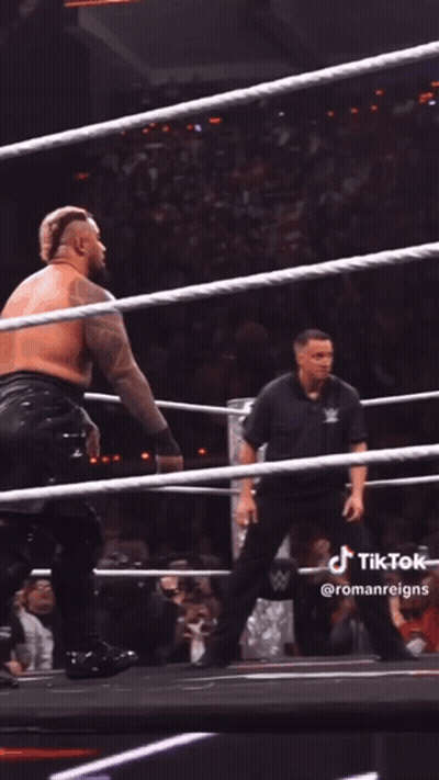 A Wrestler Is Being Lifted In The Air By Another Wrestler During A Match GIF