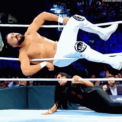 A Wrestler Is Being Lifted In The Air By Another Wrestler GIF