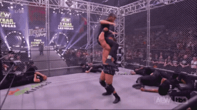 A Wrestler Is Being Lifted In The Air By Another Wrestler In A Ring That Says Kings GIF