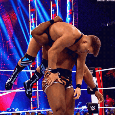 A Wrestler Is Carrying Another Wrestler On His Back GIF