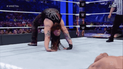 A Wrestler Is Doing A Handstand In The Ring GIF