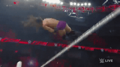 A Wrestler Is Falling Through A Ring While Wearing Purple Shorts GIF