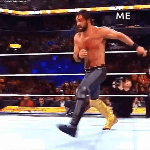 A Wrestler Is Jumping In The Air In A Wrestling Ring With The Word Me On The Bottom . GIF