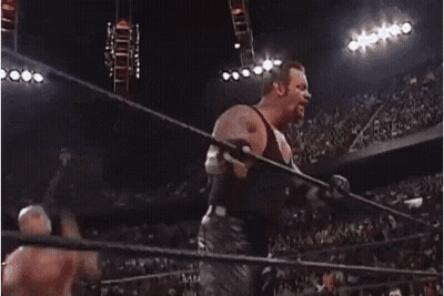A Wrestler Is Jumping Over A Rope In A Ring GIF