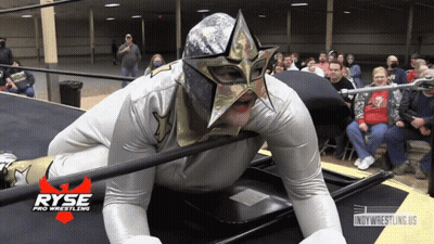 A Wrestler Is Laying On The Floor With A Ryse Pro Wrestling Logo In The Background GIF