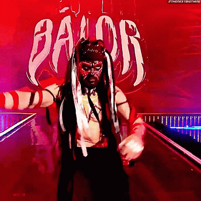 A Wrestler Is Standing In Front Of A Sign That Says " Balor " GIF