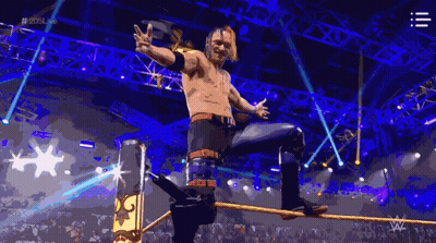 A Wrestler Is Standing On A Rope In A Wrestling Ring With The Hashtag # 2015Live GIF