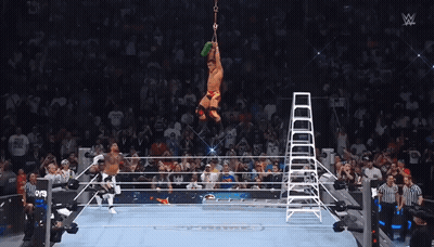A Wrestler Is Suspended From A Ladder In The Air GIF