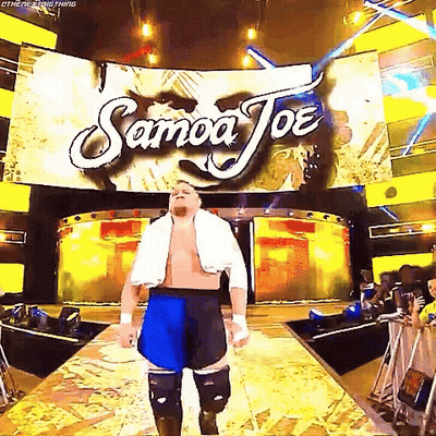 A Wrestler Is Walking Down A Ramp In Front Of A Large Screen That Says Samoa Joe . GIF
