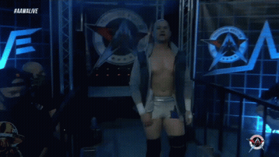 A Wrestler Is Walking Out Of A Ring With The Aawalive Logo In The Background GIF