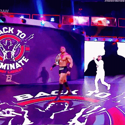 A Wrestler Is Walking Through A Tunnel With The Words Back To Dominate On The Wall Behind Him GIF