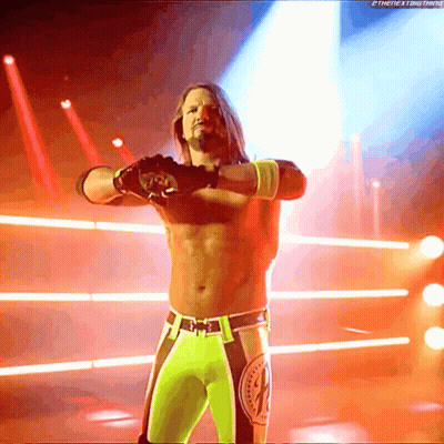 A Wrestler Stands In A Ring With His Arms Outstretched In Front Of A Screen That Says Thenextbig Thing GIF