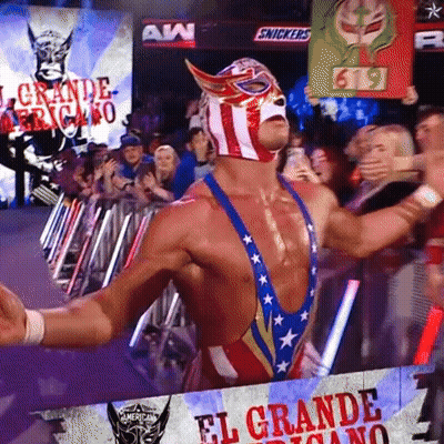 A Wrestler Stands In Front Of A Banner That Says El Grande GIF