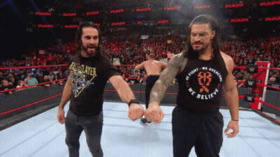 A Wrestler Wearing A Black Shirt That Says We Fight We Overcome We Believe GIF