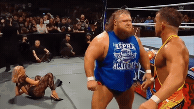 A Wrestler Wearing A Blue Shirt That Says Alpha Junior On It GIF
