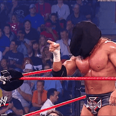 A Wrestler Wearing A Mask And A Belt That Says The Next Thing On It GIF