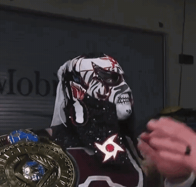 A Wrestler Wearing A Mask With The Word Wow On It GIF
