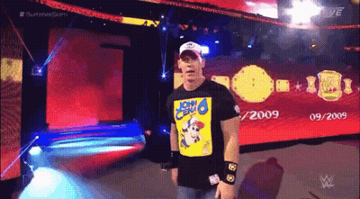 A Wrestler Wearing A Shirt That Says John Cena On It GIF