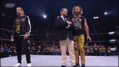 A Wrestler Wearing A Shirt That Says Rock N ' Roll GIF