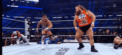 A Wrestler Wearing A Shirt That Says ' Rocky Road ' On It GIF