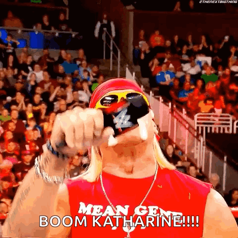 A Wrestler Wearing Sunglasses And A Red Shirt Says Boom Katharine GIF
